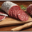 Can you explain the regional variations in Italian cured meats, such as soppressata and mortadella?